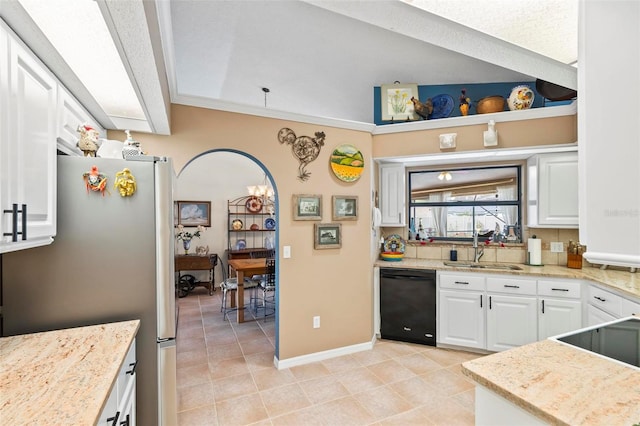 kitchen featuring a sink, white cabinetry, freestanding refrigerator, light stone countertops, and dishwasher