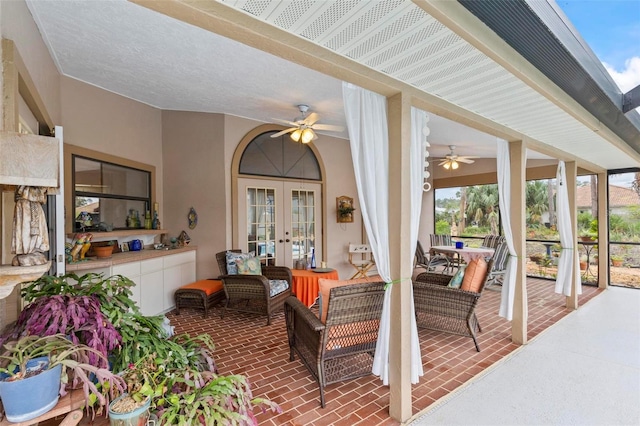 view of patio / terrace with ceiling fan, french doors, and an outdoor living space