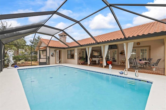 pool with french doors, a patio area, and a lanai