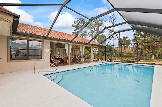 outdoor pool with french doors, glass enclosure, and a patio