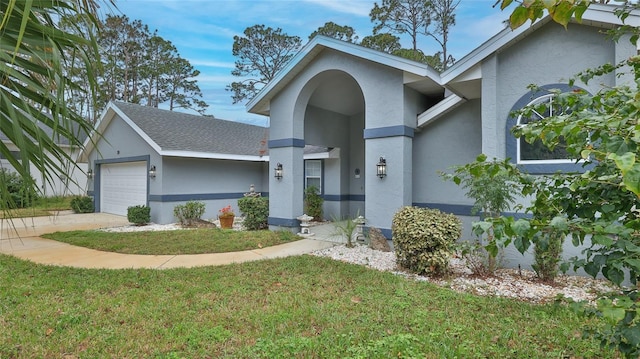 view of front of property with a front yard and a garage