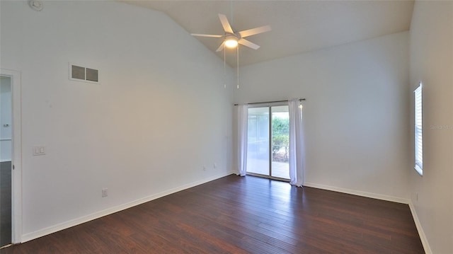 empty room with dark hardwood / wood-style flooring, ceiling fan, and high vaulted ceiling