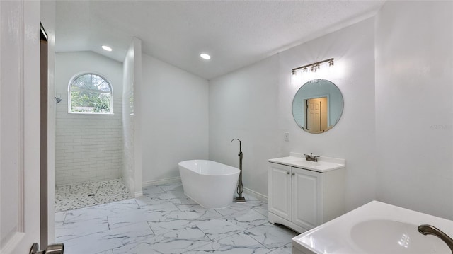 bathroom featuring a textured ceiling, lofted ceiling, shower with separate bathtub, and vanity