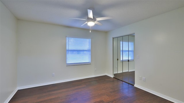 spare room featuring dark hardwood / wood-style flooring and ceiling fan