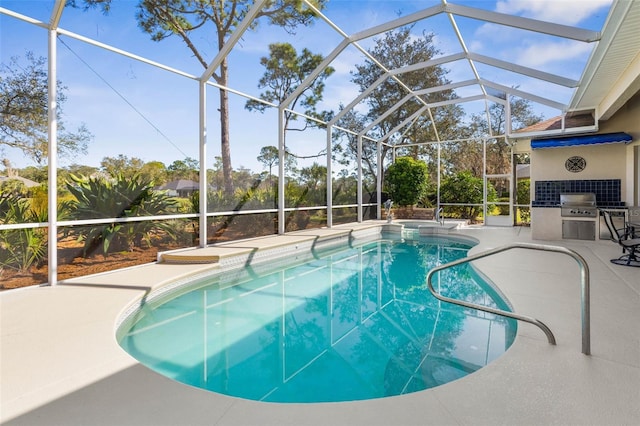 view of pool with a patio, grilling area, exterior kitchen, and a lanai