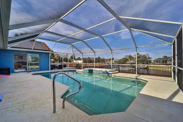 pool featuring glass enclosure, a patio, and a jacuzzi