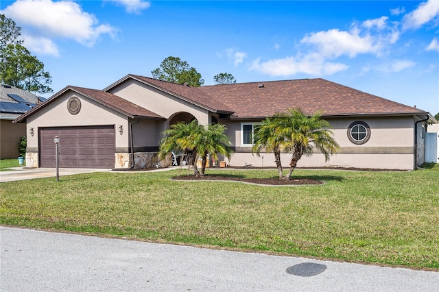 single story home featuring a front lawn and a garage