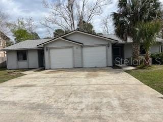 ranch-style house with an attached garage and driveway