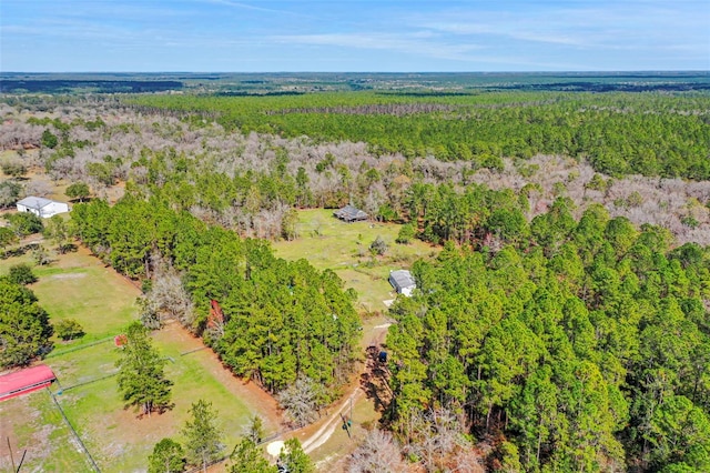 birds eye view of property featuring a forest view