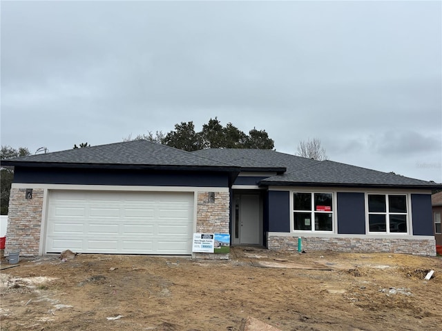 8 Burnham Ln, Palm Coast, FL 32137 - view of front of property with stone siding, an attached garage, roof with shingles, and driveway