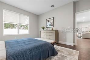 8 Burnham Ln, Palm Coast, FL 32137 - bedroom with baseboards and wood finished floors