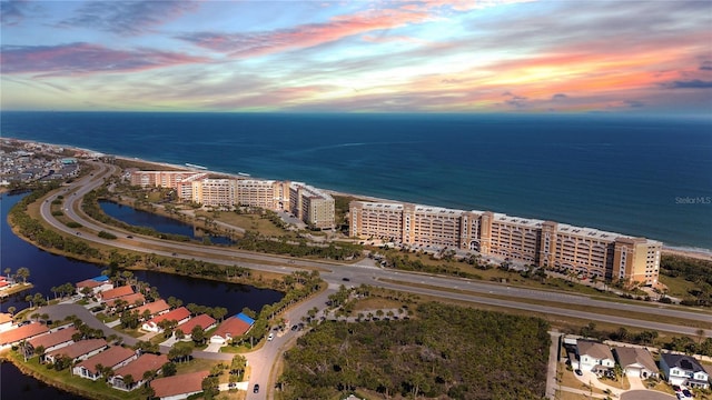 aerial view at dusk with a water view and a city view