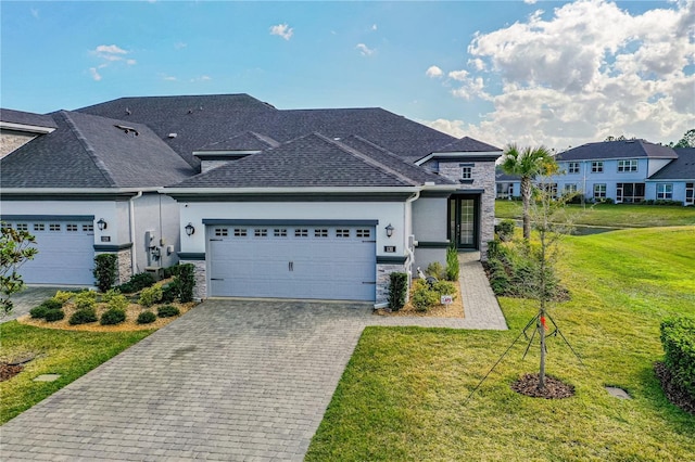 view of front of house featuring a garage and a front lawn