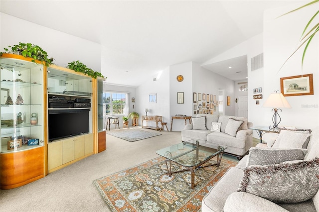 carpeted living room featuring vaulted ceiling and visible vents