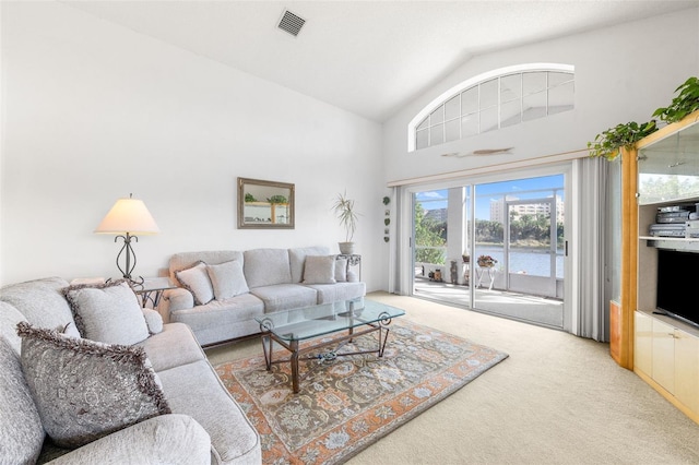 carpeted living area featuring lofted ceiling and visible vents