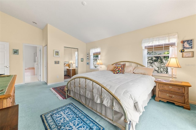 bedroom featuring lofted ceiling, light colored carpet, and baseboards