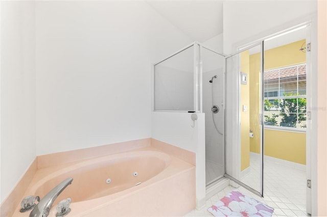 bathroom with a stall shower, tile patterned flooring, and a jetted tub