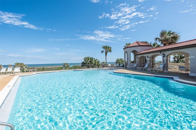 community pool featuring a patio and fence