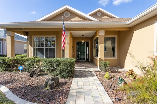 doorway to property featuring stucco siding