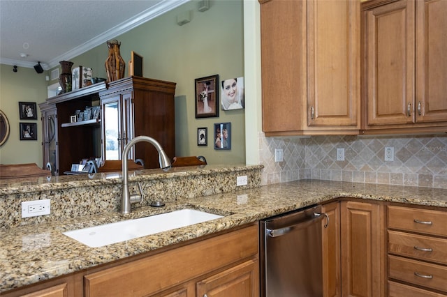 kitchen featuring brown cabinets, stainless steel dishwasher, a sink, and crown molding