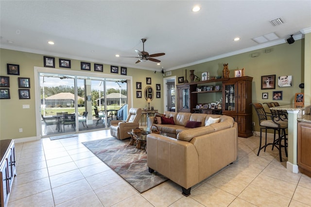 living room with light tile patterned floors, crown molding, and recessed lighting