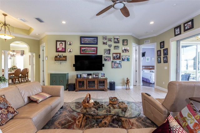 living room with arched walkways, light tile patterned floors, visible vents, and crown molding