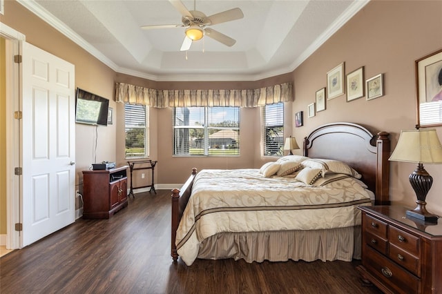 bedroom with baseboards, a tray ceiling, ceiling fan, and dark wood-type flooring