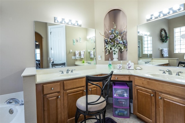 bathroom with vanity, a bath, and tile patterned floors