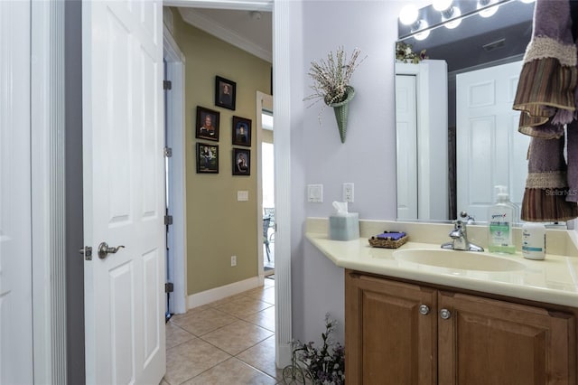 bathroom with ornamental molding, visible vents, vanity, and tile patterned floors