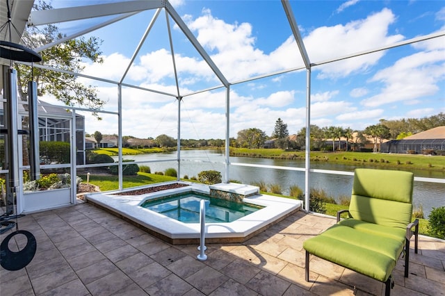 exterior space with a water view and a hot tub