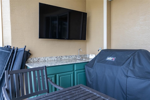 view of patio with a grill and a sink