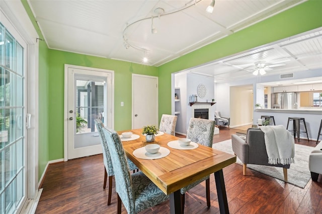 dining room with ceiling fan and dark hardwood / wood-style floors