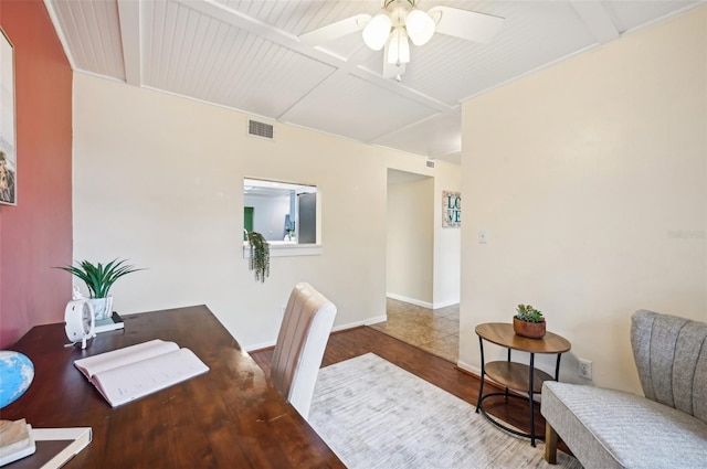 dining room featuring beamed ceiling, ceiling fan, and wood-type flooring