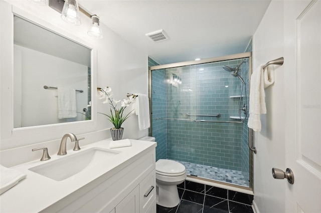 bathroom featuring vanity, an enclosed shower, toilet, and tile patterned flooring