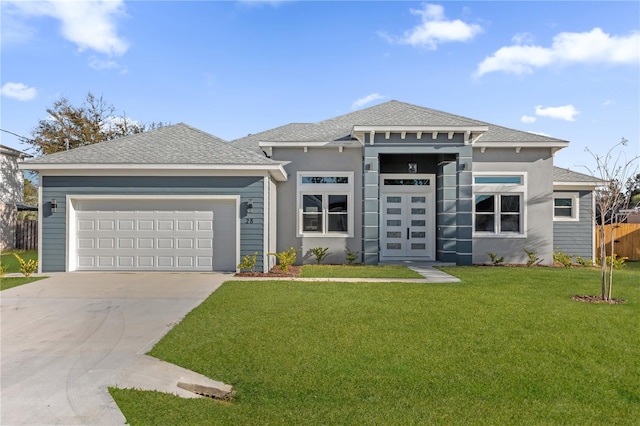 prairie-style home featuring a garage and a front yard