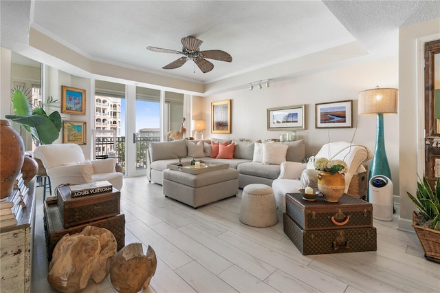 200 Ocean Crest Dr Unit 306, Palm Coast, FL 32137 - living room with a textured ceiling, ceiling fan, light wood-type flooring, and crown molding