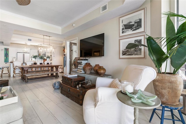 200 Ocean Crest Dr Unit 306, Palm Coast, FL 32137 - living room featuring crown molding, a tray ceiling, visible vents, and an inviting chandelier