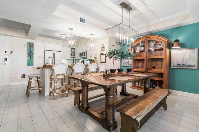 200 Ocean Crest Dr Unit 306, Palm Coast, FL 32137 - dining room with visible vents, an inviting chandelier, ornamental molding, light wood-style floors, and baseboards