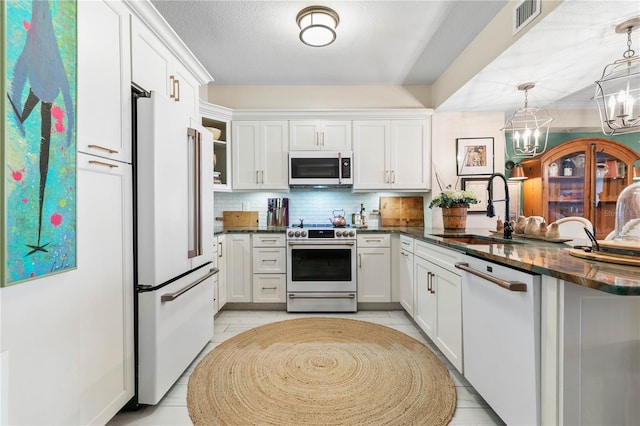 200 Ocean Crest Dr Unit 306, Palm Coast, FL 32137 - kitchen featuring white appliances, tasteful backsplash, visible vents, white cabinets, and a sink