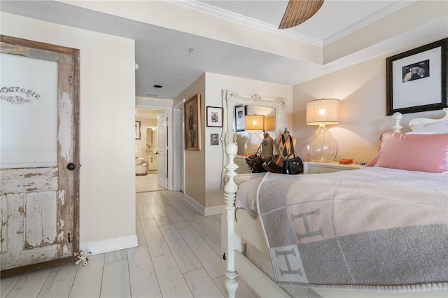 200 Ocean Crest Dr Unit 306, Palm Coast, FL 32137 - bedroom with ornamental molding, wood tiled floor, baseboards, and ensuite bathroom
