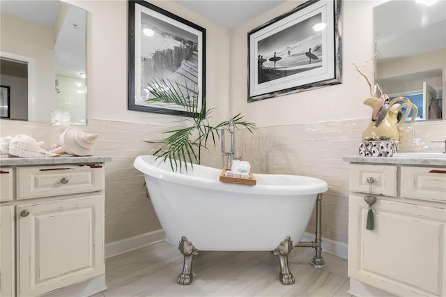 200 Ocean Crest Dr Unit 306, Palm Coast, FL 32137 - bathroom with a freestanding bath, wainscoting, a sink, and tile walls