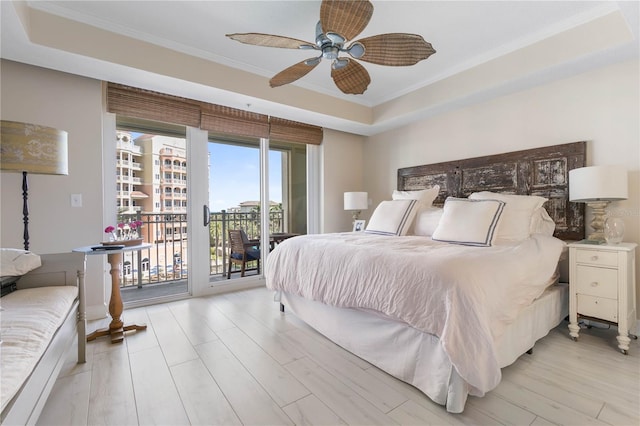 200 Ocean Crest Dr Unit 306, Palm Coast, FL 32137 - bedroom featuring ceiling fan, light wood-style flooring, access to exterior, ornamental molding, and a tray ceiling