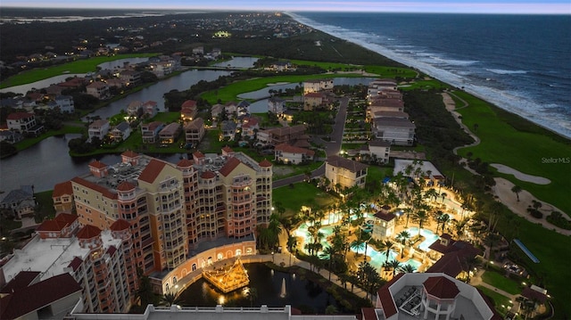 200 Ocean Crest Dr Unit 306, Palm Coast, FL 32137 - aerial view at dusk featuring a water view and a beach view