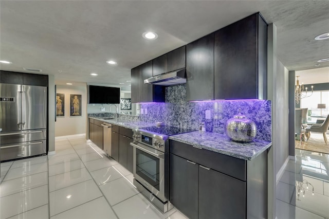 kitchen featuring light stone countertops, under cabinet range hood, high end appliances, and a sink