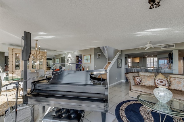 living room with light tile patterned floors, visible vents, stairway, ceiling fan, and a textured ceiling