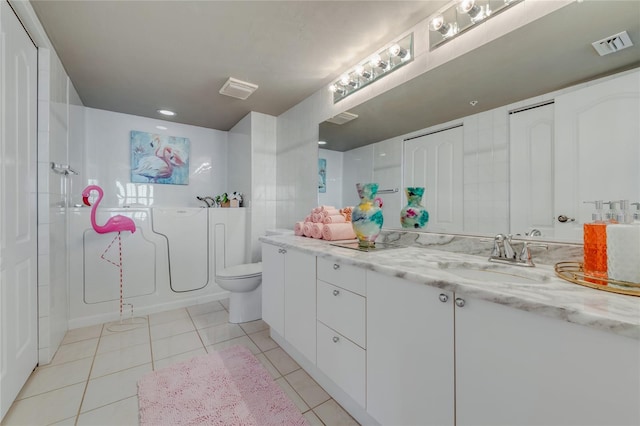 bathroom featuring toilet, tile patterned flooring, visible vents, and a closet