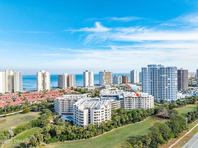 birds eye view of property featuring a water view and a city view