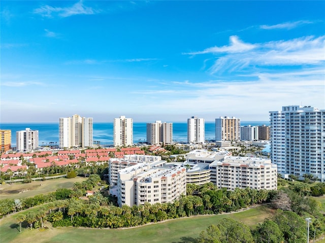 drone / aerial view featuring a view of city and a water view