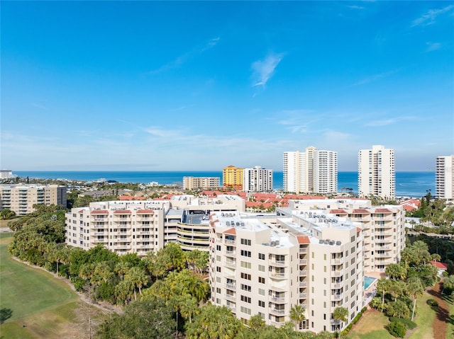 birds eye view of property featuring a water view and a city view