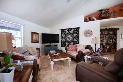 living area featuring vaulted ceiling and ceiling fan